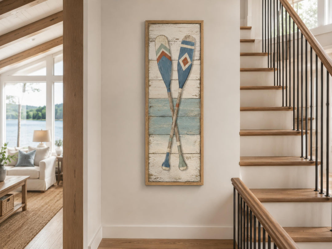 Tall narrow canvas wall art featuring two crossed rustic oars on a weathered wood-plank background.