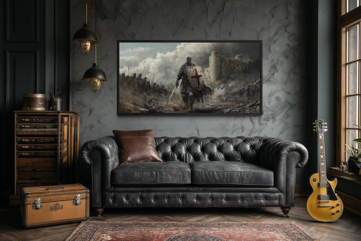 Extra large canvas print of a crusader knight in battle, framed above a black leather sofa.
