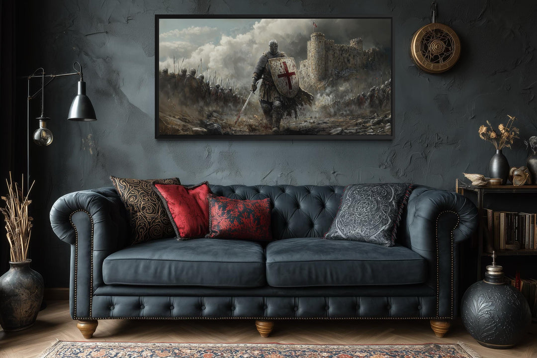 Extra large canvas print of a crusader knight in battle, framed above a dark tufted sofa.