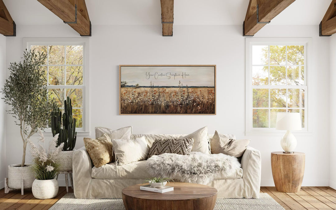 Custom scripture canvas print with a wildflower landscape above a sofa in a rustic living room.