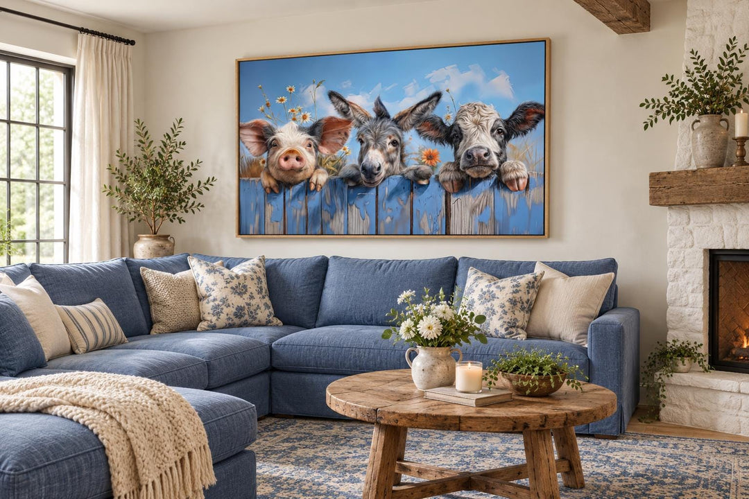 Framed canvas wall art of a pig, donkey, and baby cow looking over a blue fence in a living room.