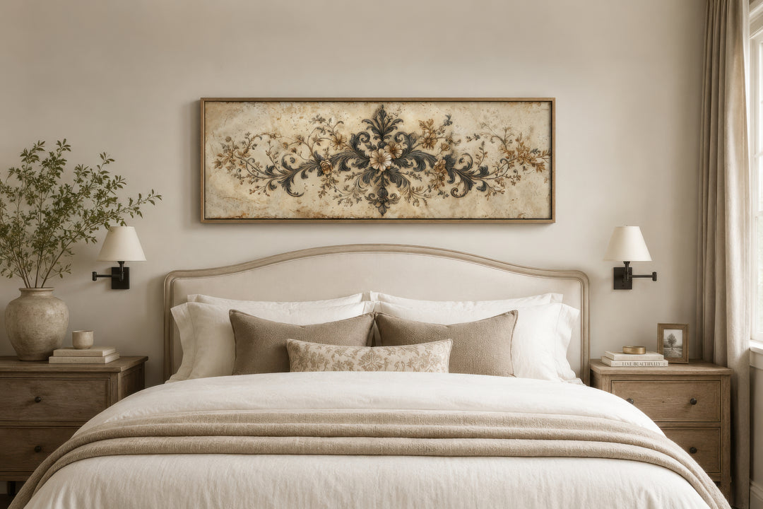 Antique long narrow damask canvas wall art with a neutral floral design hanging above a bed.