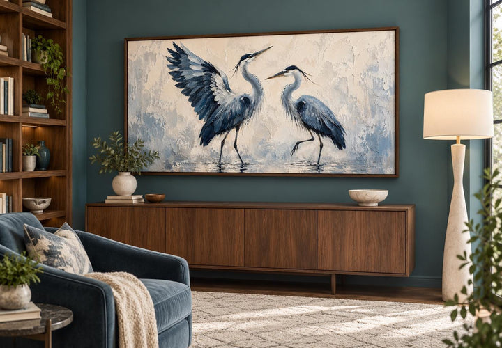 Dancing Blue Herons navy and cream canvas wall art displayed above a wooden sideboard in a room.