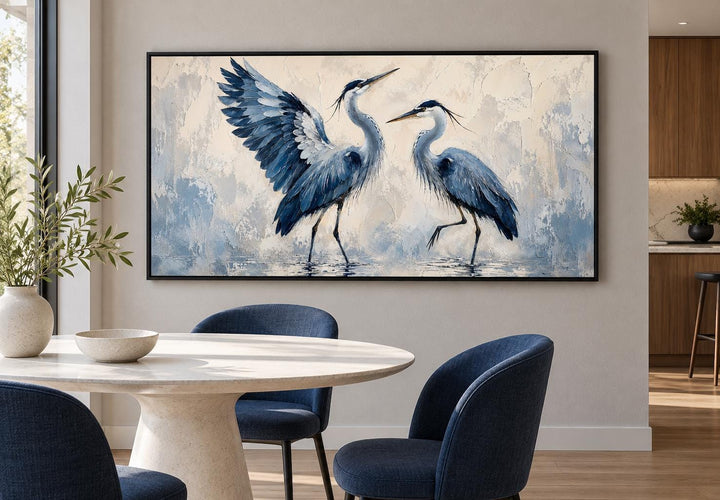 Dancing Blue Herons canvas wall art featuring two blue birds on a cream background in a dining room.