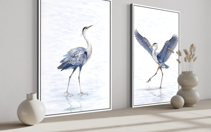 Set of two watercolor heron canvas prints in white frames, featuring blue and gray birds.