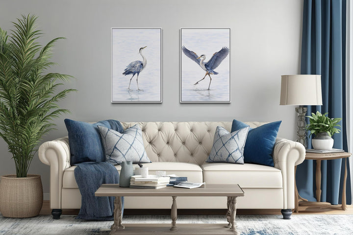 Set of two watercolor canvas prints featuring elegant dancing herons in a serene living room.