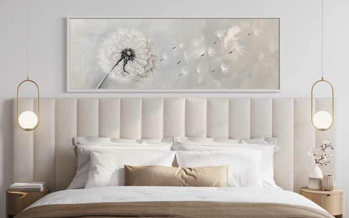 Dandelion Boho Grey White Long Horizontal Framed Canvas Wall Art above a modern upholstered bed.