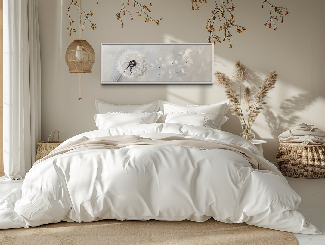 Horizontal framed canvas wall art featuring a white dandelion on a grey background above a bed.