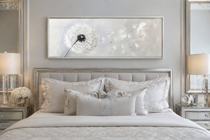 Dandelion boho grey and white long horizontal framed canvas wall art hanging above a bed.
