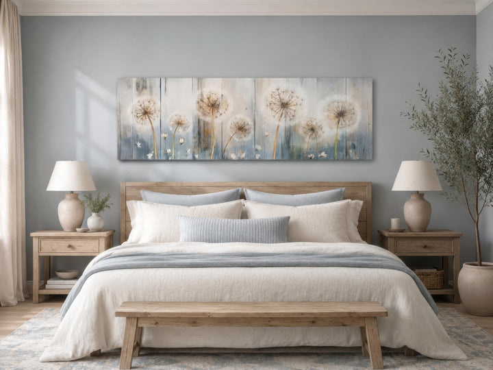 Long horizontal dandelion canvas wall art in a farmhouse bedroom with blue and cream decor.