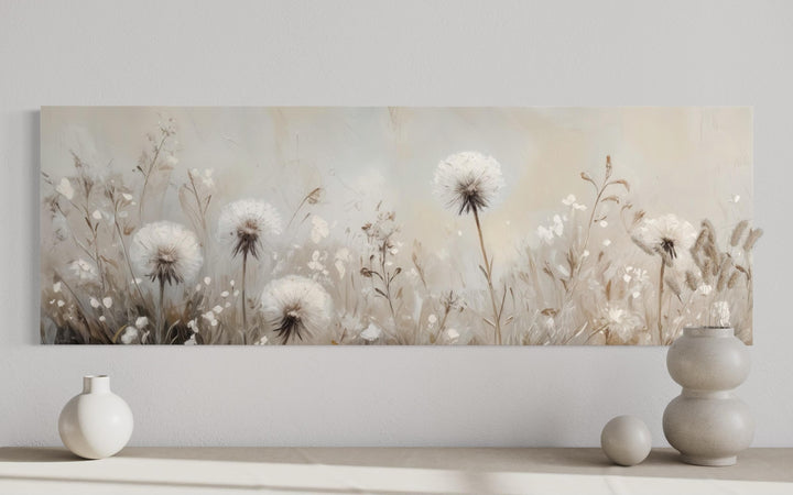 Long horizontal wall art of white dandelions in a neutral beige and taupe farmhouse field.