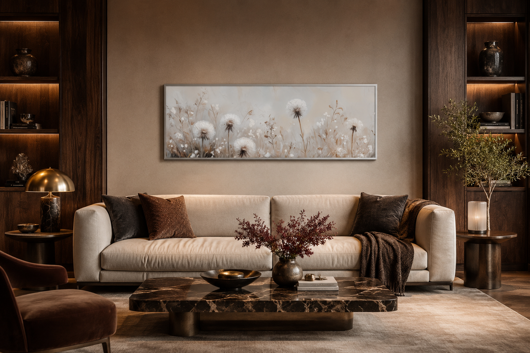 Long horizontal wall art of white dandelions in neutral beige tones above a modern sofa.