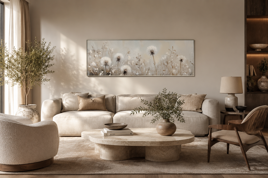 Long horizontal wall art of white dandelions in neutral beige tones above a modern sofa.