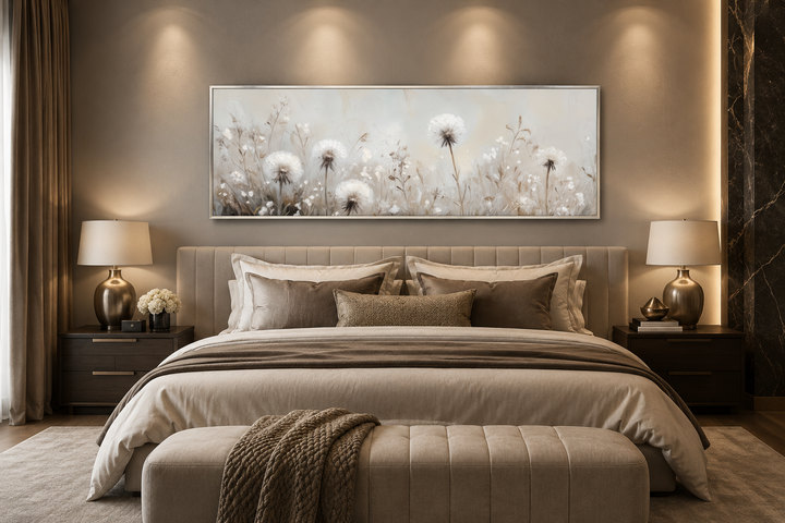 Long horizontal wall art of white dandelions in neutral beige tones hanging above a bed.