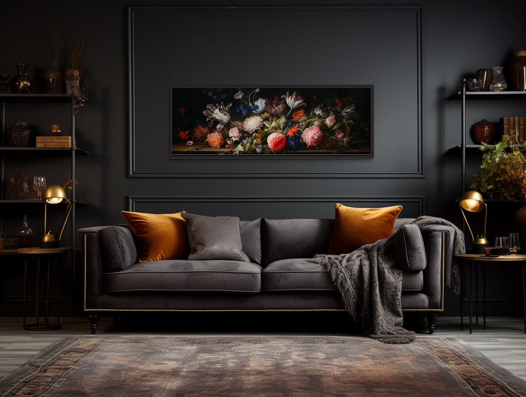 Dark Academia antique flowers moody horizontal framed canvas wall art above a dark velvet sofa.