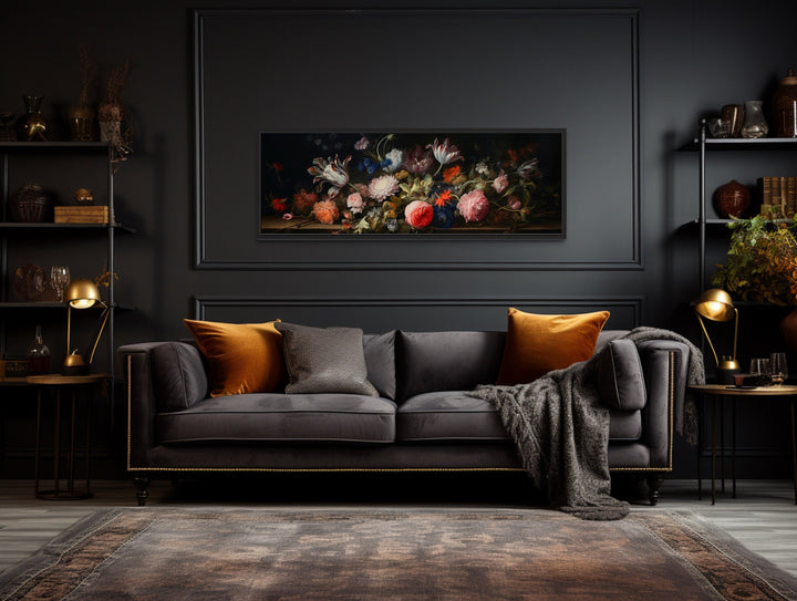 Dark Academia antique flowers moody horizontal framed canvas wall art above a dark velvet sofa.