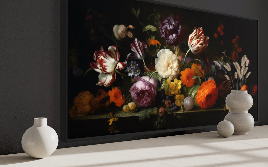 Framed dark academia floral canvas print on a wall with minimalist white vases on a shelf.