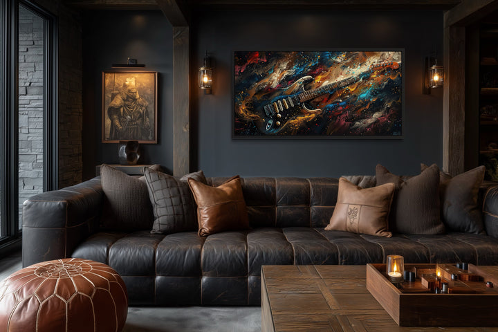 Dark colorful electric guitar framed canvas wall art above a leather sofa in a music room.