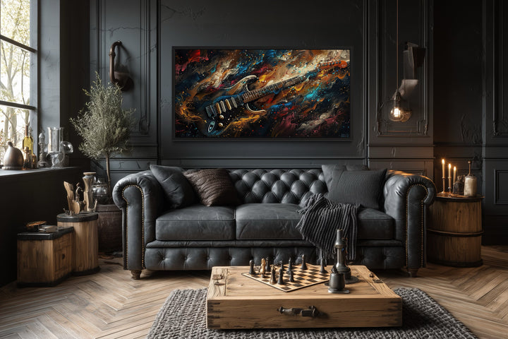 Dark colorful electric guitar framed canvas wall art in a modern music room with a black sofa.