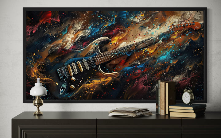 Framed canvas wall art of a dark colorful electric guitar in an abstract, vibrant paint splash style
