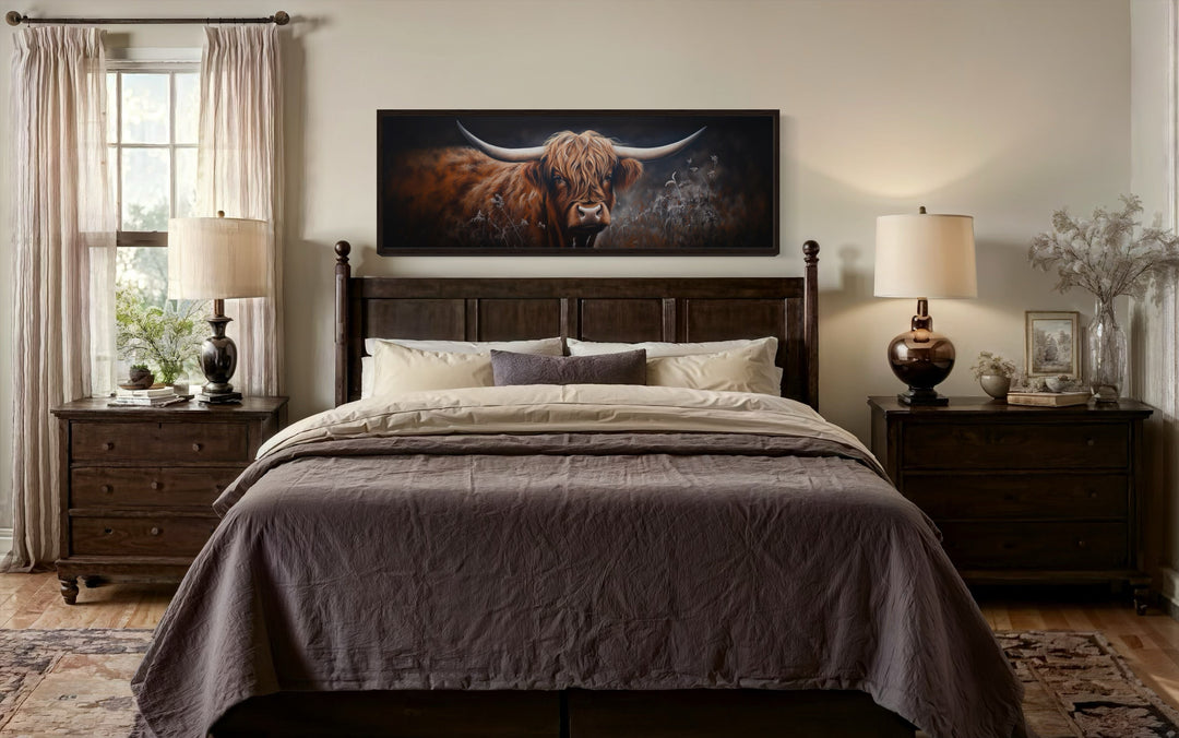 Dark Highland cow long horizontal canvas wall art hanging above a bed in a farmhouse bedroom.