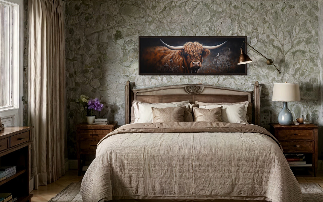 Dark Highland cow long horizontal canvas wall art hanging above a bed in a rustic bedroom.