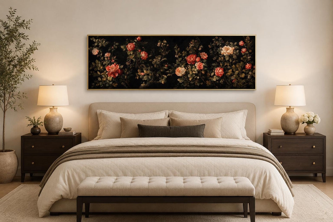 Long horizontal canvas print of red and cream roses on a dark background above a bed.
