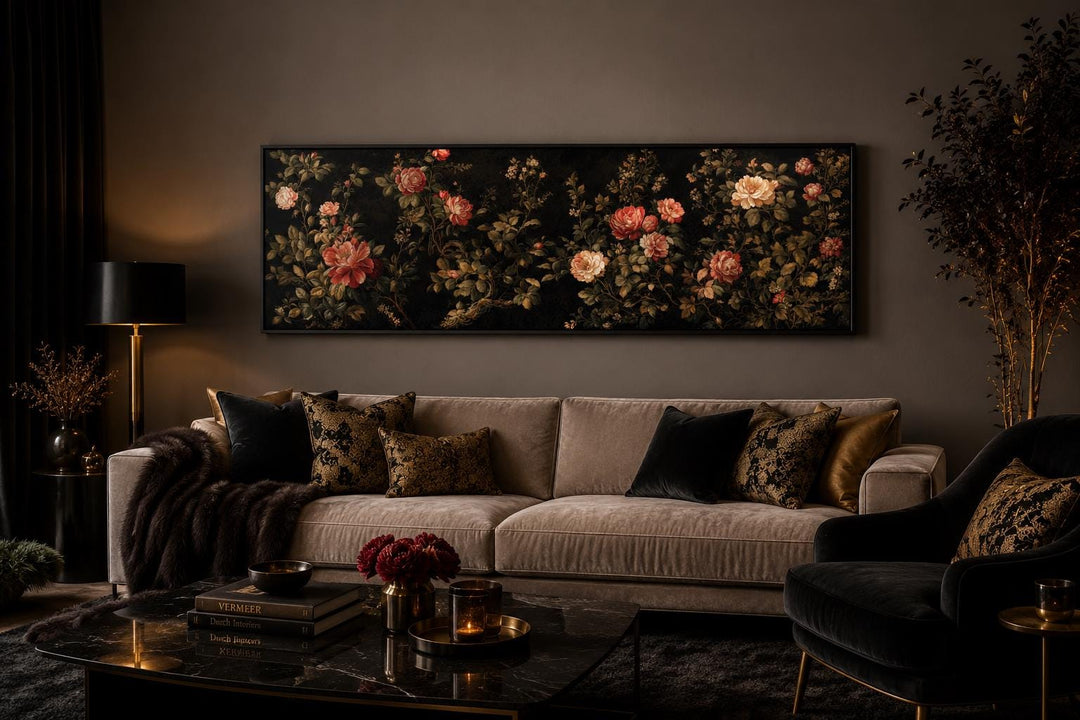 Long horizontal canvas print of red and cream roses on a dark background above a velvet sofa.