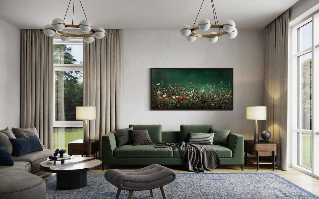 Dark moody green wildflowers field at night framed canvas wall art hanging above a green sofa.