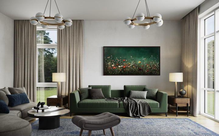 Dark moody green wildflowers field at night framed canvas wall art hanging above a green sofa.