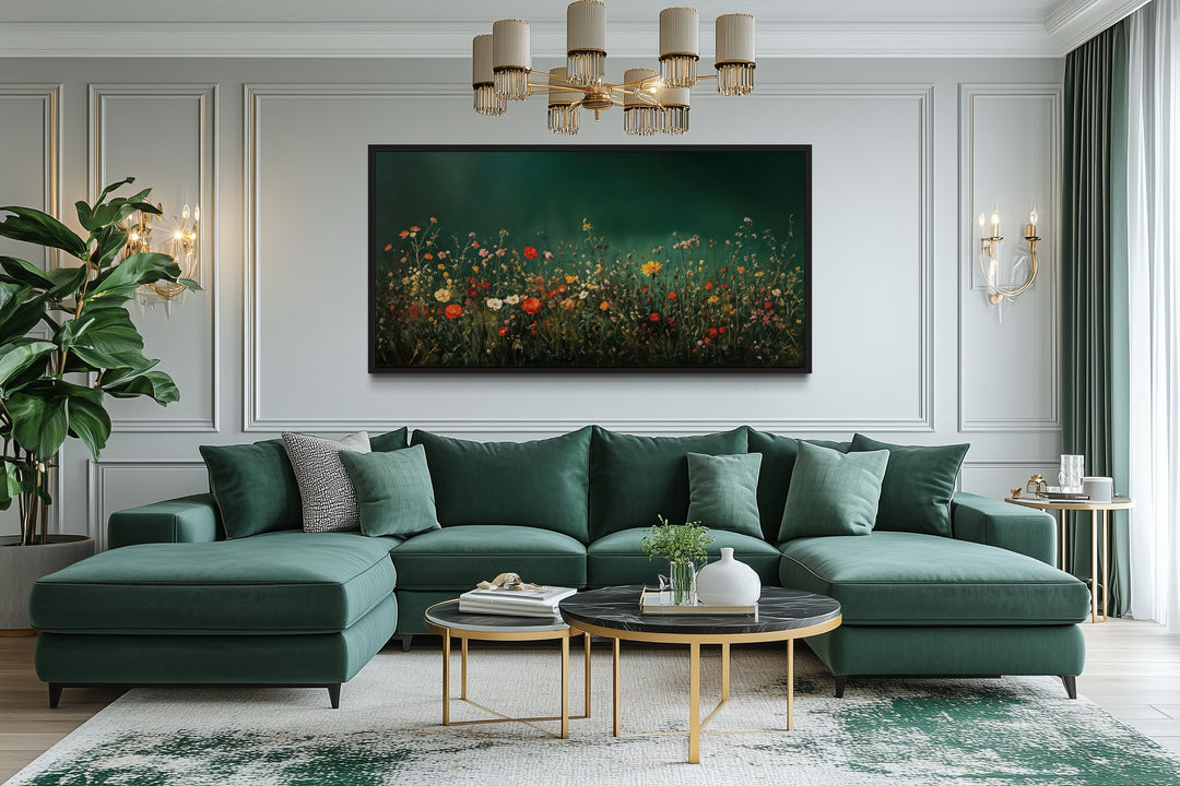 Dark moody green wildflowers field at night framed canvas wall art above a green sectional sofa.