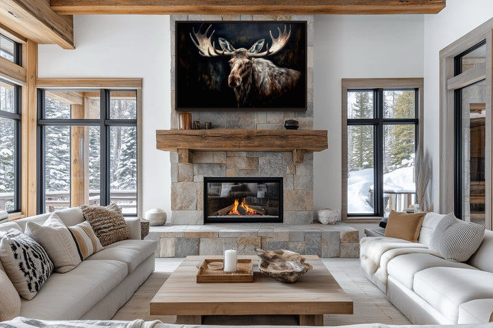 Dark Moose Painting Framed Canvas Wall Art hanging above a stone fireplace in a rustic living room.