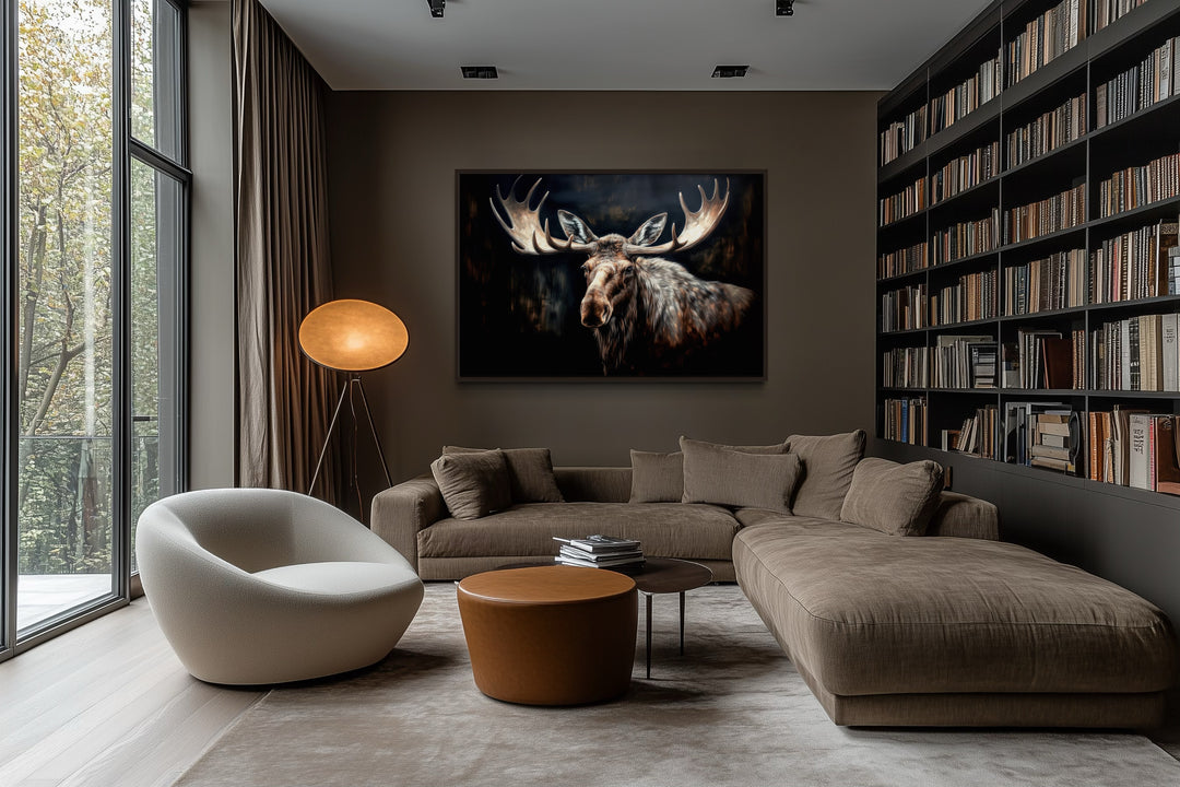 Dark Moose Painting Framed Canvas Wall Art hanging in a modern living room above a brown sofa.
