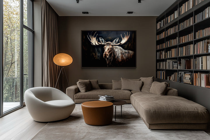 Dark Moose Painting Framed Canvas Wall Art hanging in a modern living room above a brown sofa.