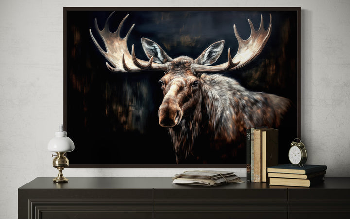 Framed canvas wall art of a moose with large antlers against a dark, atmospheric background.