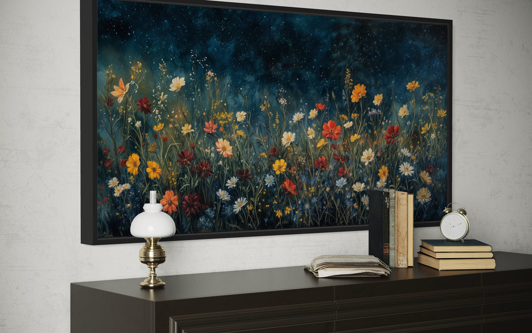 Framed canvas painting of vibrant orange and red wildflowers under a dark blue starlit night sky.