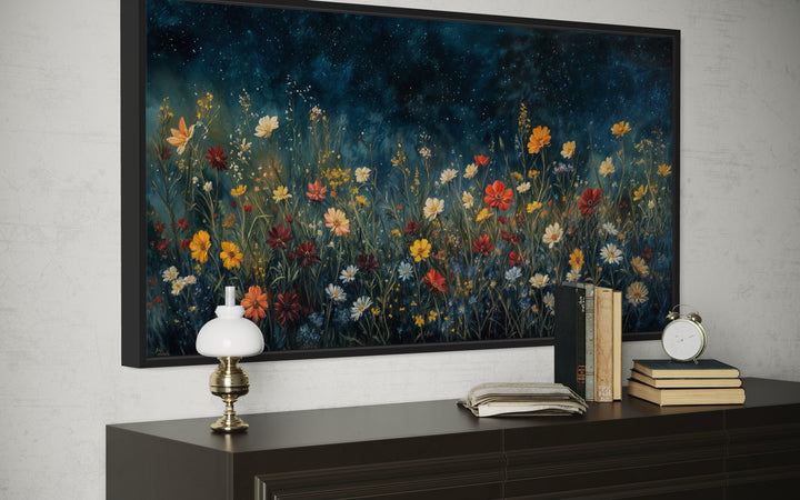 Framed canvas painting of vibrant orange and red wildflowers under a dark blue starlit night sky.