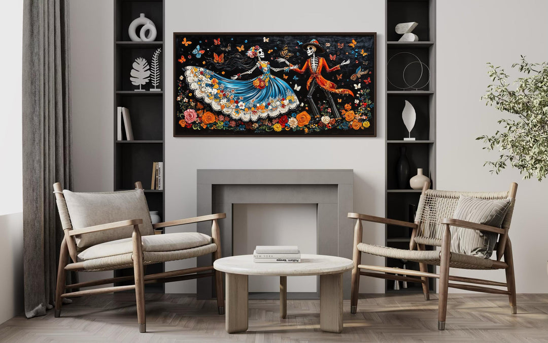 Day of the Dead dancing skeletons canvas wall art displayed above a modern fireplace.