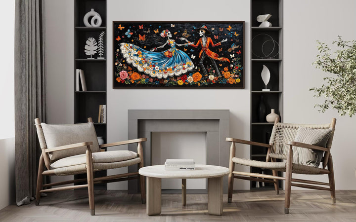 Day of the Dead dancing skeletons canvas wall art displayed above a modern fireplace.