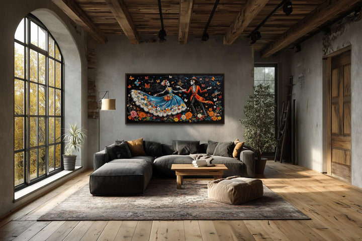 Day of the Dead dancing skeletons canvas wall art in a modern living room setting.
