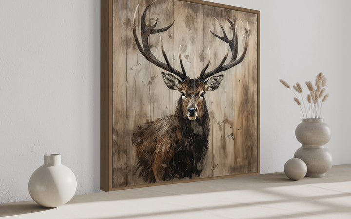 Rustic framed canvas wall art featuring a detailed deer portrait on a distressed wood background.