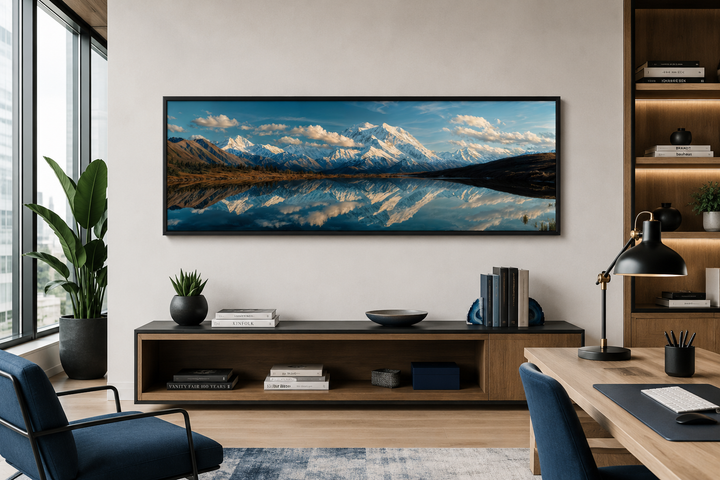 Panoramic wall art of Denali and Wonder Lake in a black frame above a modern wooden console.