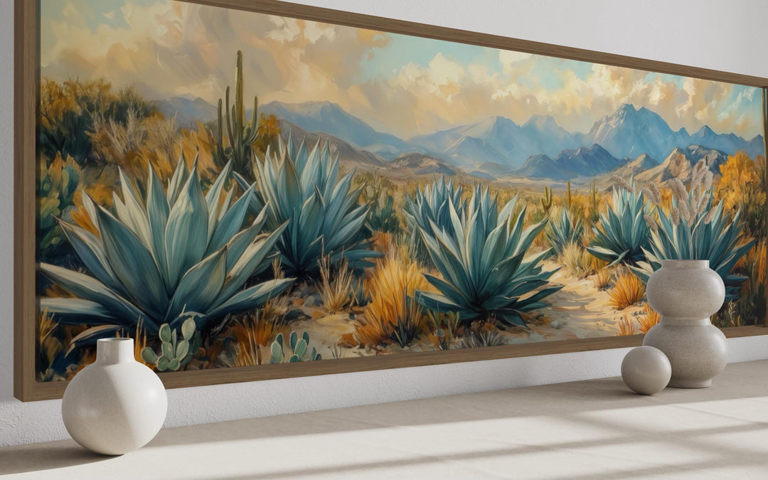Panoramic southwestern wall art featuring agave plants, mountains, and cacti in a wooden frame.