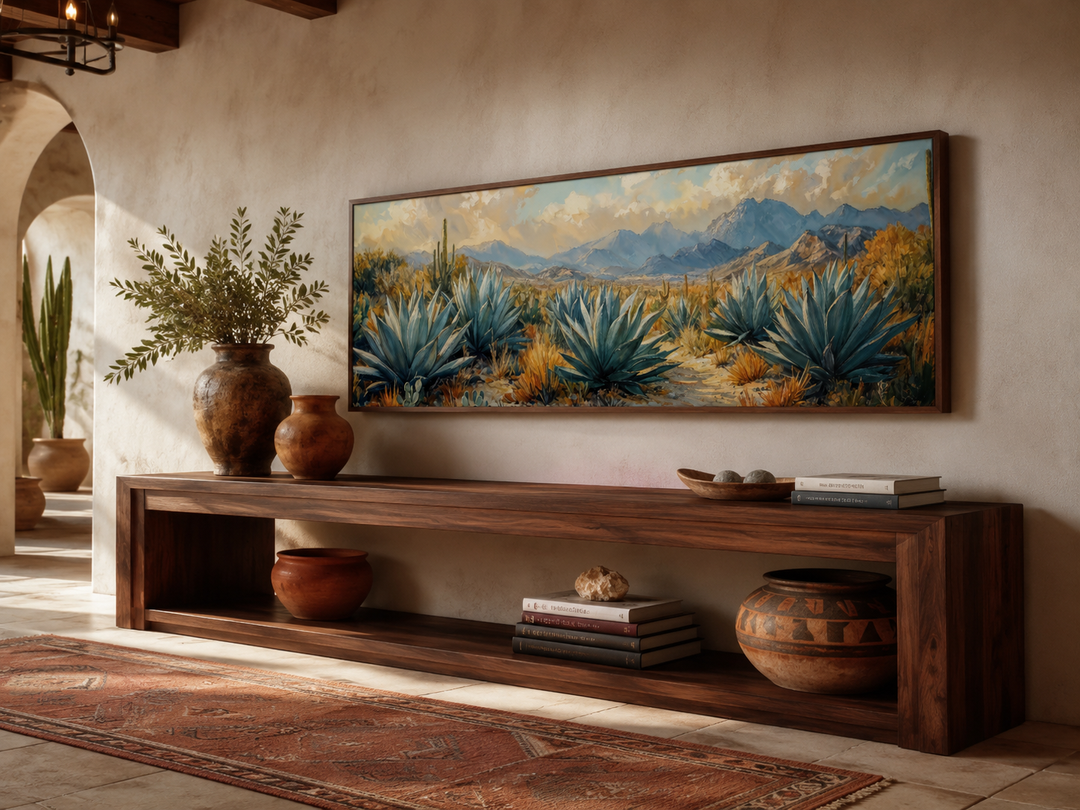 Panoramic southwestern wall art featuring blue agave plants and mountains in a dark wood frame.