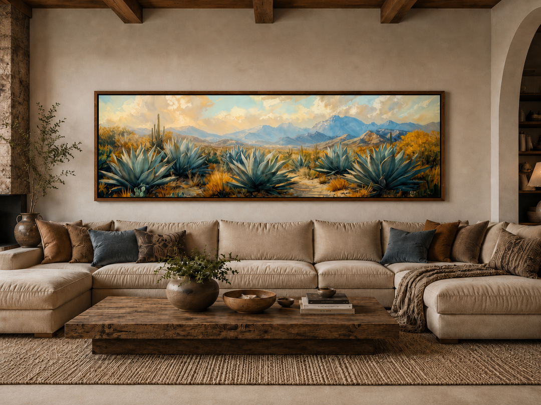 Panoramic desert agave painting in teal and gold tones above a neutral sectional sofa.