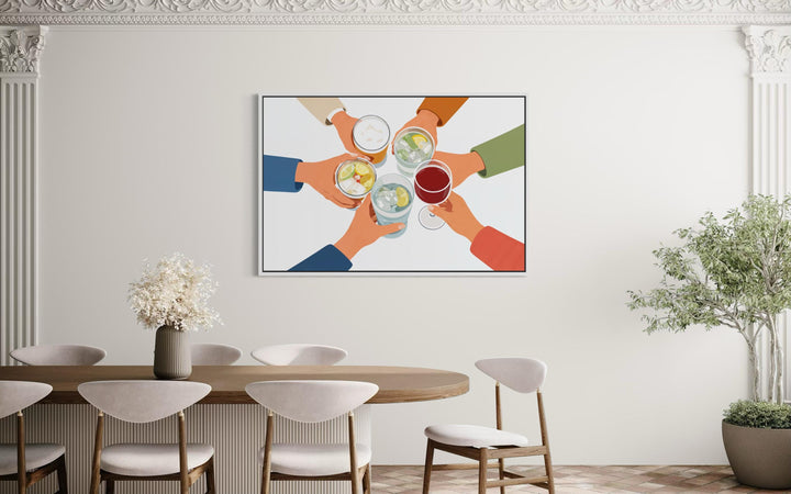 A modern canvas print of friends toasting drinks hangs above a minimalist dining table and chairs.