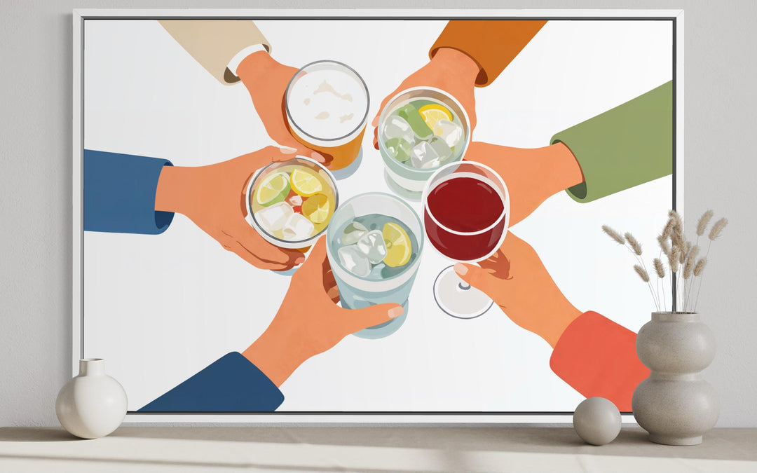 A modern canvas print of friends toasting with various drinks, displayed in a white frame.