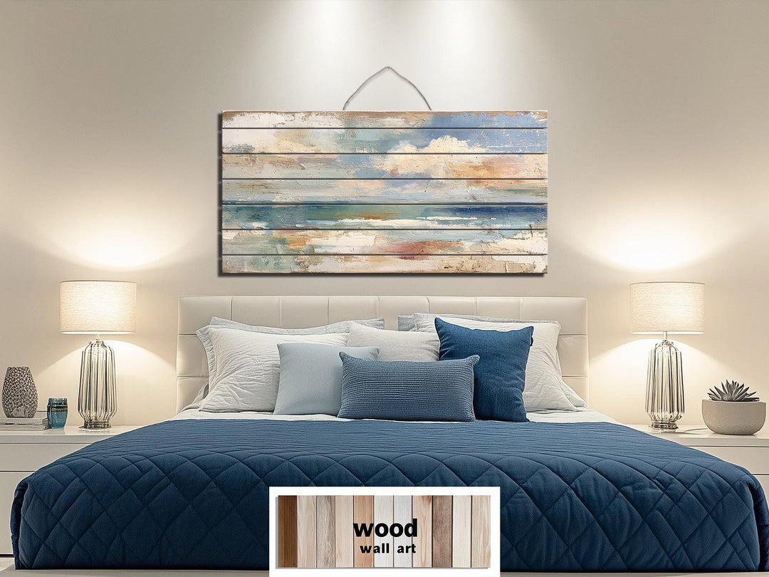 Distressed ocean horizon rustic wood wall art with soft blues and sandy tones.