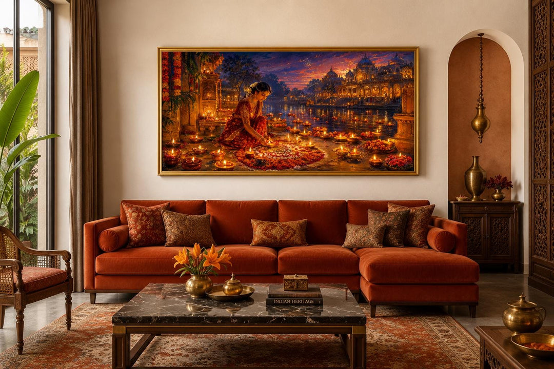 Diwali canvas wall art of a woman lighting diyas above a burnt orange sofa in a living room.