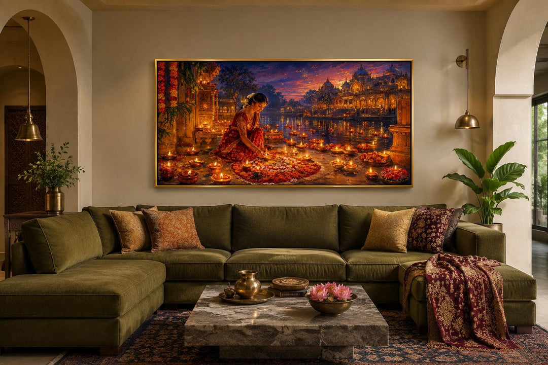 Diwali canvas wall art of a woman lighting diyas above an olive green sofa in a living room.